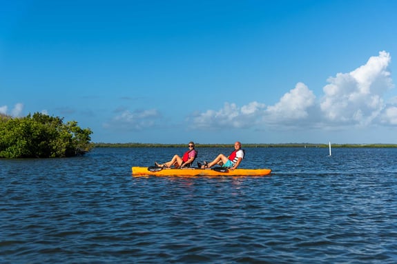 Kayakers cruising over clear blue waters in Canaveral National Seashore in New Smyrna Beacha 
