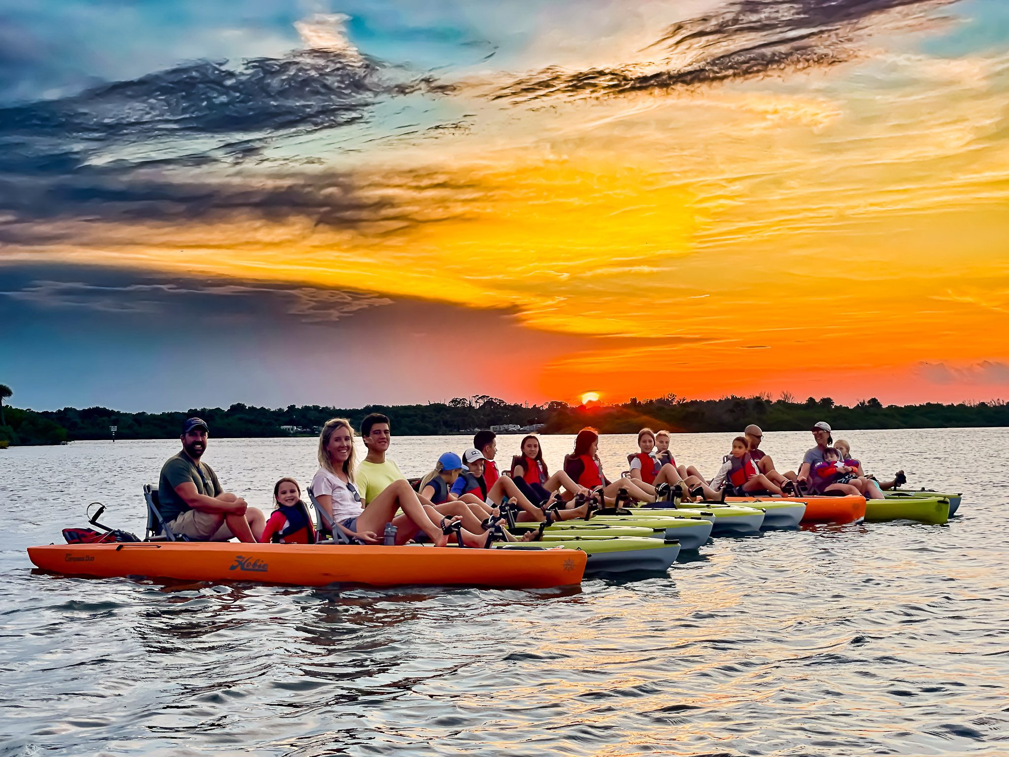 Group picture of full tour group on guided kayak tour with sunsets on the Indian River North along Canaveral National Seashore. These National Park guided kayak tours are in New Smyrna Beach nearby Orlando and Daytona Beach.